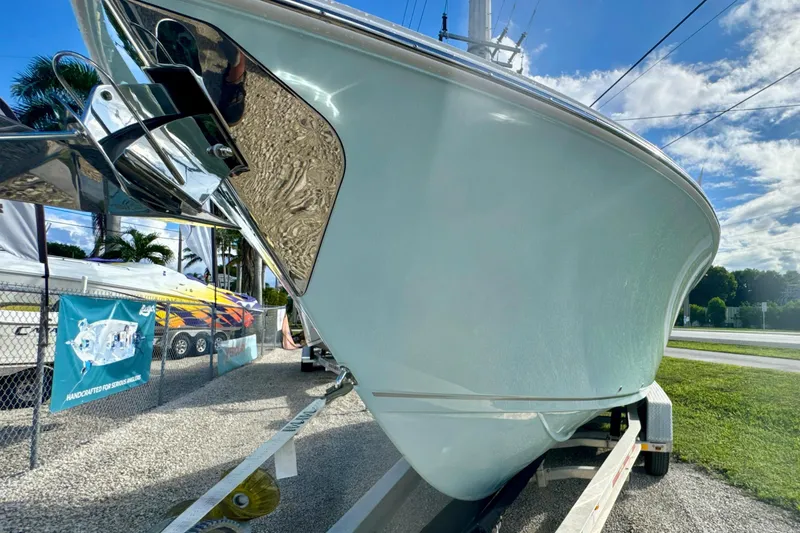 Slide: The Image of 2026 Sailfish 272 CC boat on trailer under clear blue sky. - 2