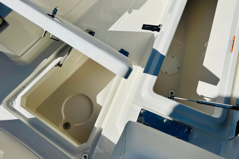 Slide: The Image of Open storage compartments on a 2026 Sailfish 272 CC boat deck. - 24