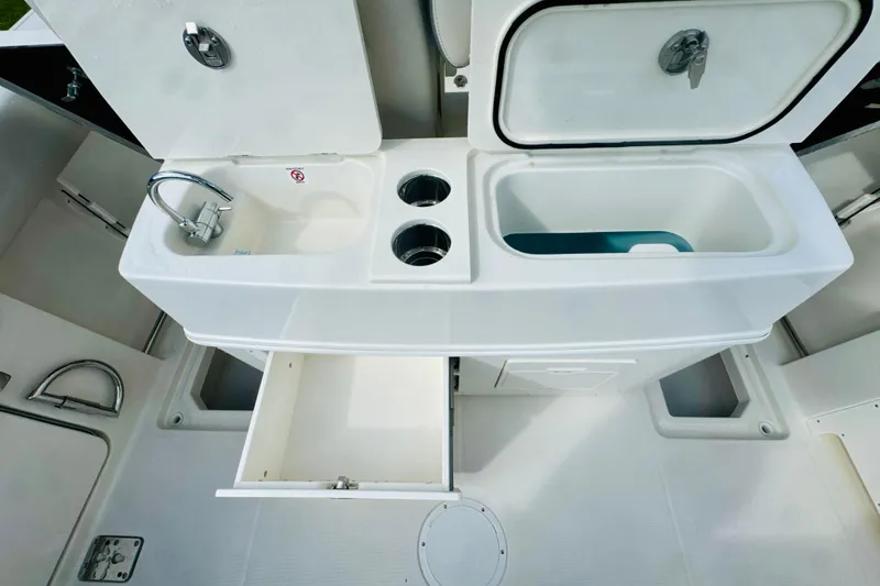 Slide: The Image of 2026 Sailfish 272 CC boat interior with sink, storage, and compartments. - 7