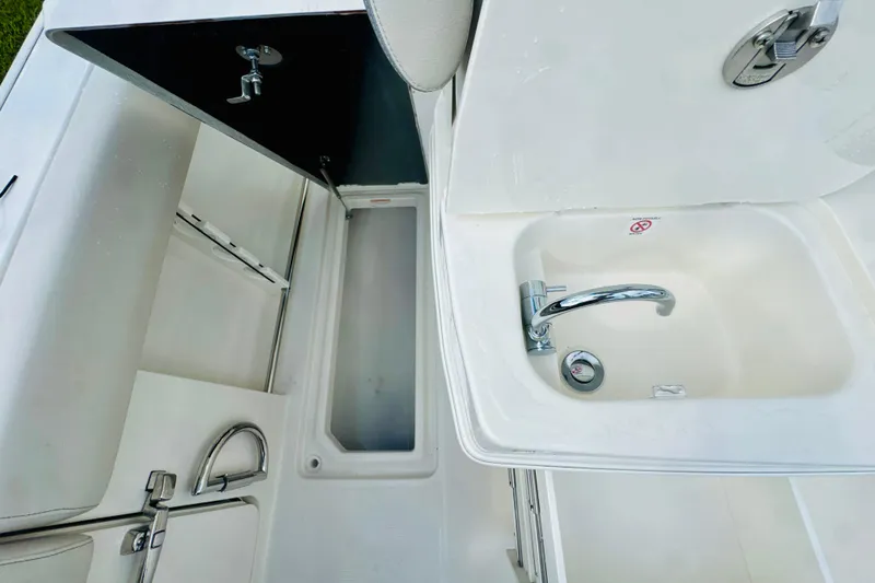 Slide: The Image of 2026 Sailfish 272 CC boat interior with sink and storage compartments. - 8