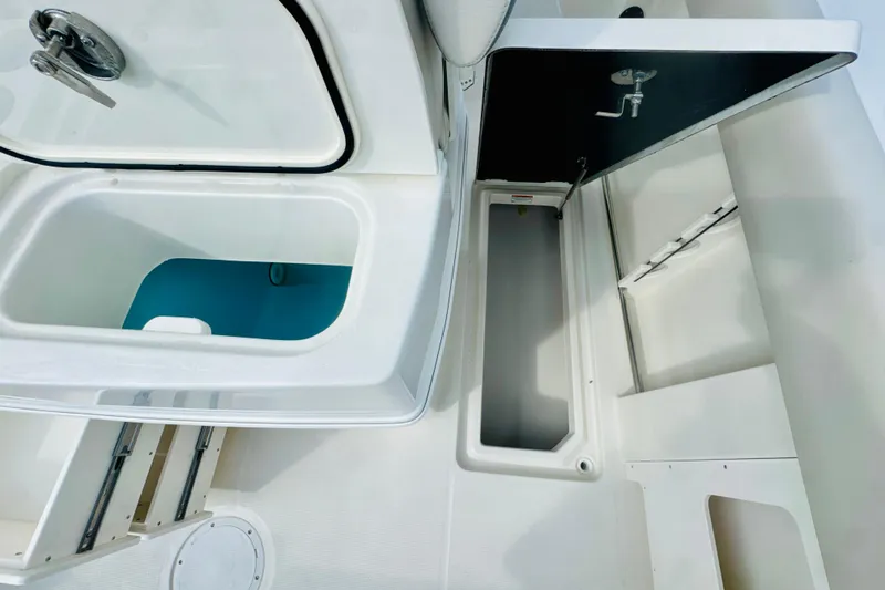 Slide: The Image of Open storage compartments on a 2026 Sailfish 272 CC boat deck. - 9