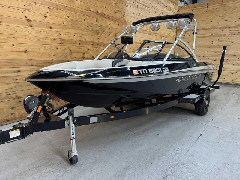 Slide: The Image of 2013 Malibu Response TXi Open Bow boat on trailer in wooden garage. - 5