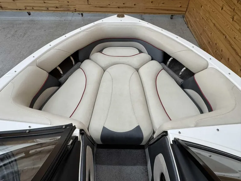 Slide: The Image of 2013 Malibu Response TXi Open Bow interior with beige and gray seating. - 9