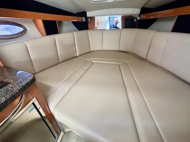 Slide: The Image of 2010 Chaparral Signature 270 cabin interior with beige seating and granite countertop. - 10