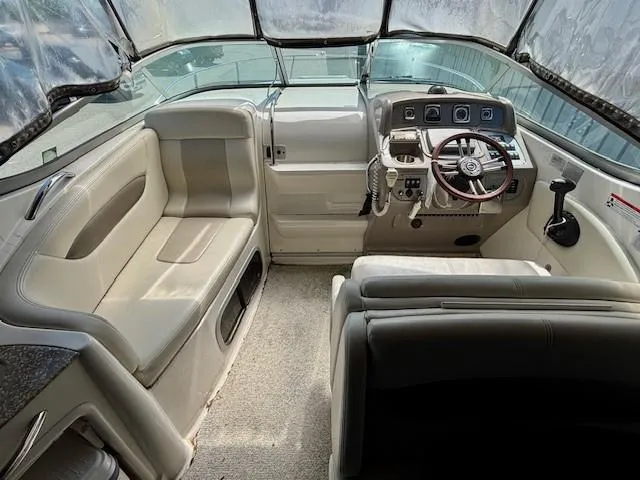 Slide: The Image of 2010 Chaparral Signature 270 boat interior with steering wheel and seating area. - 12