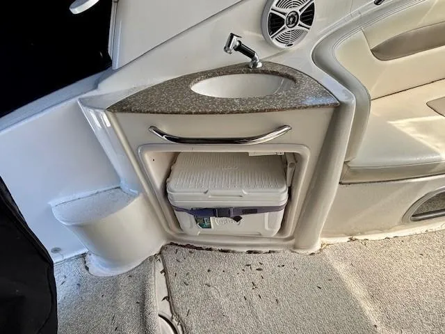 Slide: The Image of 2010 Chaparral Signature 270 boat interior with sink and storage compartment. - 13