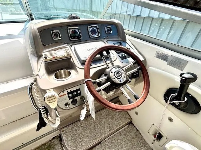 Slide: The Image of 2010 Chaparral Signature 270 boat dashboard with steering wheel and navigation controls. - 16