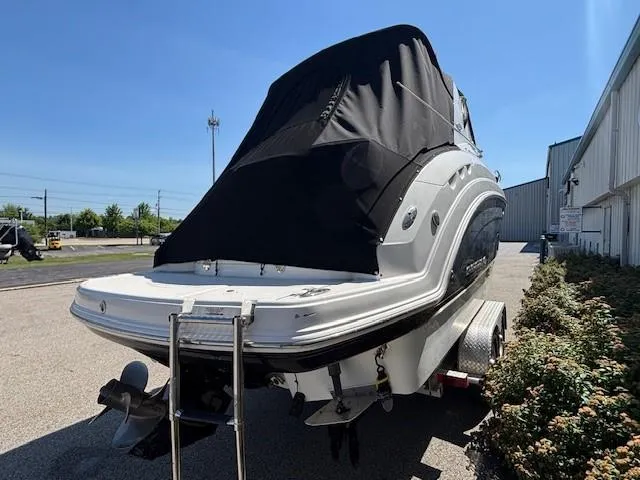 Slide: The Image of 2010 Chaparral Signature 270 boat on trailer, covered, parked outdoors. - 17