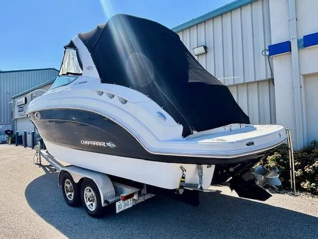 Slide: The Image of 2010 Chaparral Signature 270 boat on trailer, covered, parked outdoors. - 20