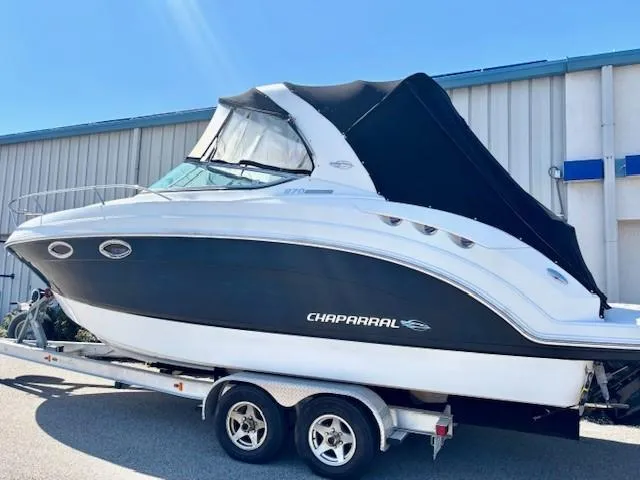 Slide: The Image of 2010 Chaparral Signature 270 boat on trailer, black and white exterior, parked outdoors. - 21