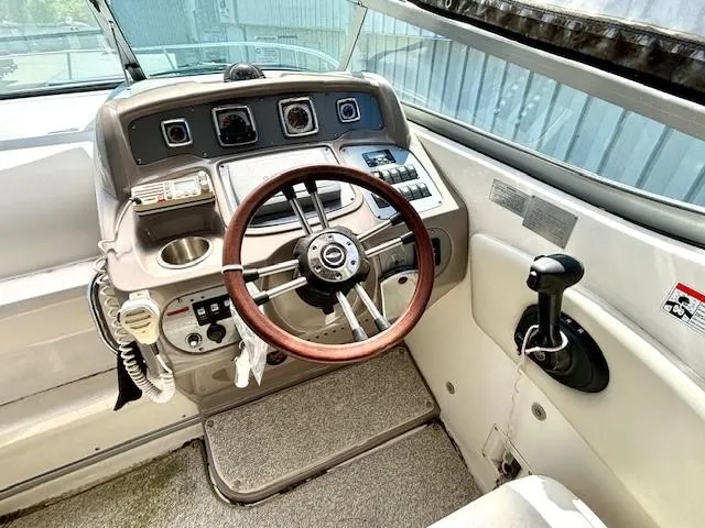 Slide: The Image of 2010 Chaparral Signature 270 helm with wood steering wheel and control panel. - 4