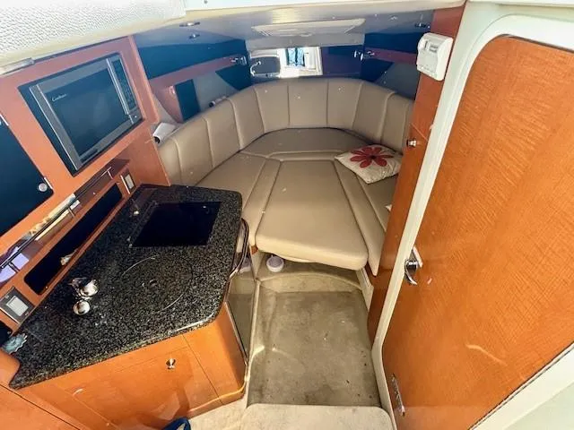 Slide: The Image of Interior of 2010 Chaparral Signature 270 boat with kitchenette and seating area. - 6