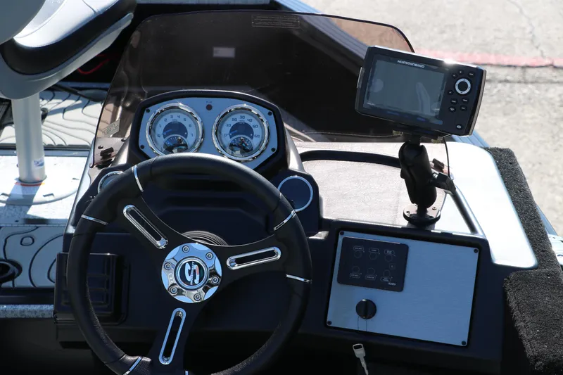 Slide: The Image of 2025 Smoker Craft Excursion 166 SC dashboard with steering wheel and navigation system. - 14