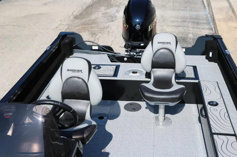 Slide: The Image of 2025 Smoker Craft Excursion 166 SC boat interior with two seats and motor. - 16
