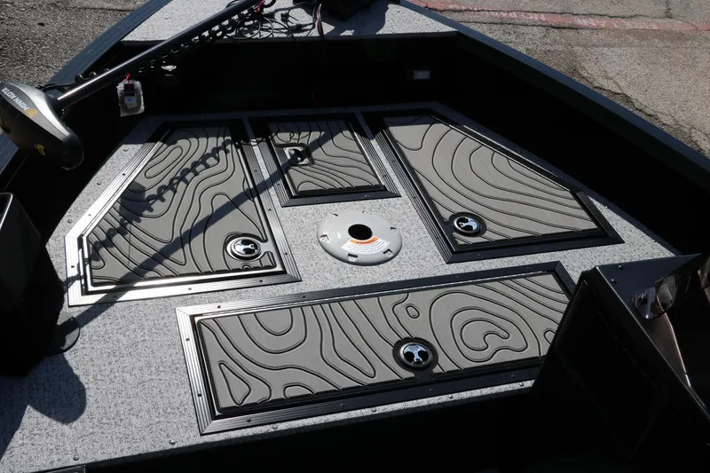 Slide: The Image of 2025 Smoker Craft Excursion 166 SC boat deck with storage compartments and trolling motor. - 18