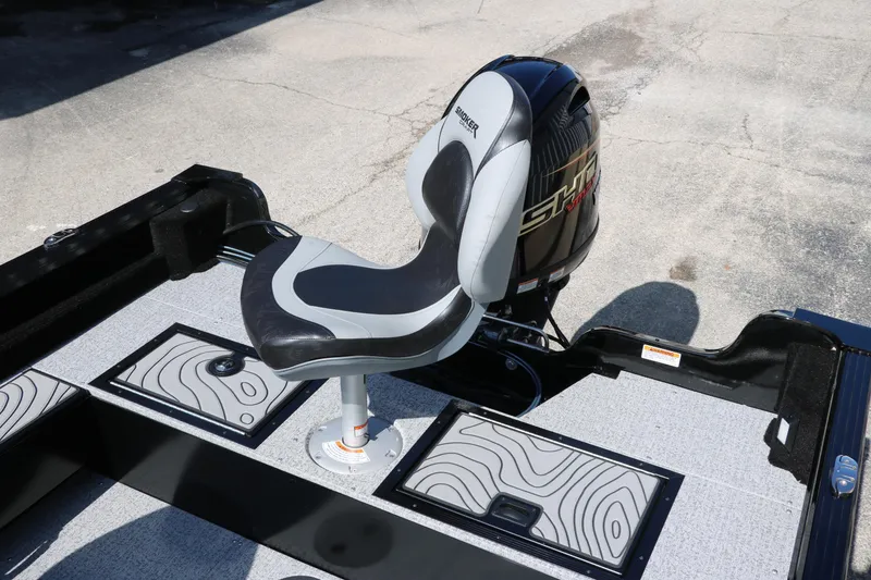 Slide: The Image of 2025 Smoker Craft Excursion 166 SC boat interior with seat and motor. - 21