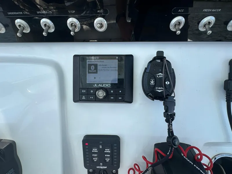 Slide: The Image of Control panel of a 2021 Sportsman Masters 227 Bay Boat with JL Audio system. - 11