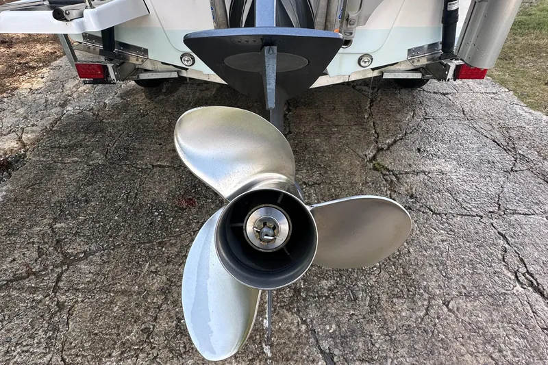 Slide: The Image of Propeller of 2021 Sportsman Masters 227 Bay Boat on cracked pavement. - 13