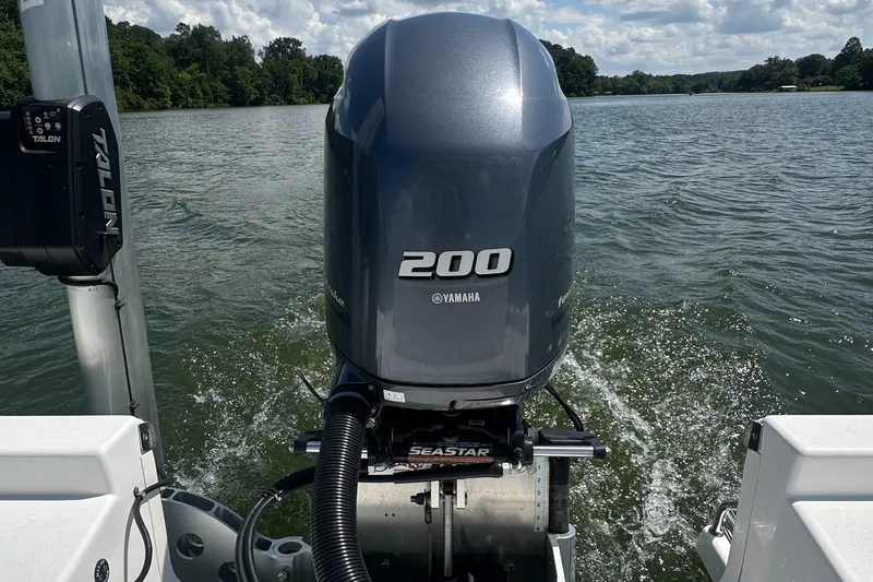 Slide: The Image of 2021 Sportsman Masters 227 Bay Boat with Yamaha 200 engine on a lake. - 14
