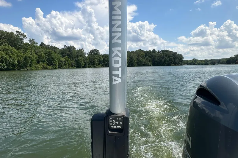 Slide: The Image of 2021 Sportsman Masters 227 Bay Boat on a scenic lake with Minn Kota equipment. - 17