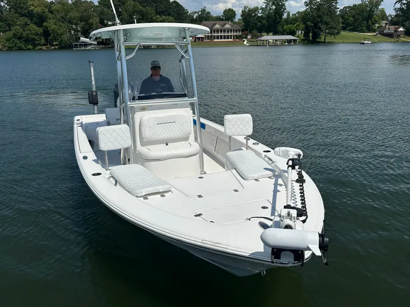 Slide: The Image of 2021 Sportsman Masters 227 Bay Boat on a serene lake. - 2