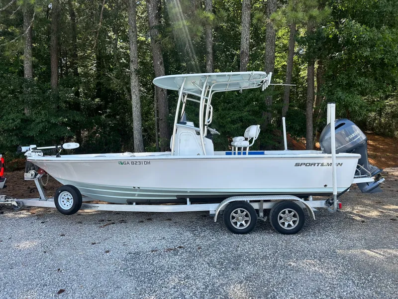 Slide: The Image of 2021 Sportsman Masters 227 Bay Boat on trailer, parked in wooded area. - 5