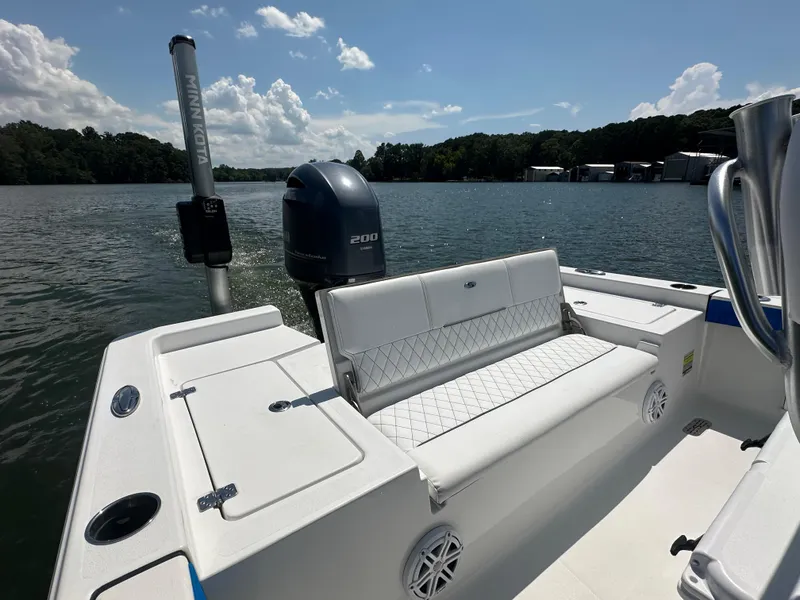 Slide: The Image of 2021 Sportsman Masters 227 Bay Boat on a sunny lake, featuring a comfortable seating area. - 9