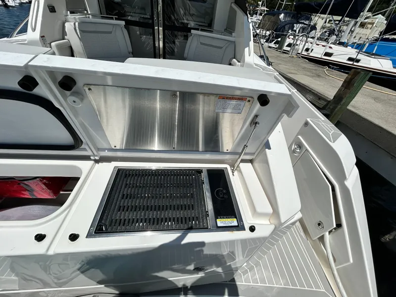 Slide: The Image of 2023 Tiara Yachts 43 LE outdoor grill station on deck, docked at marina. - 10