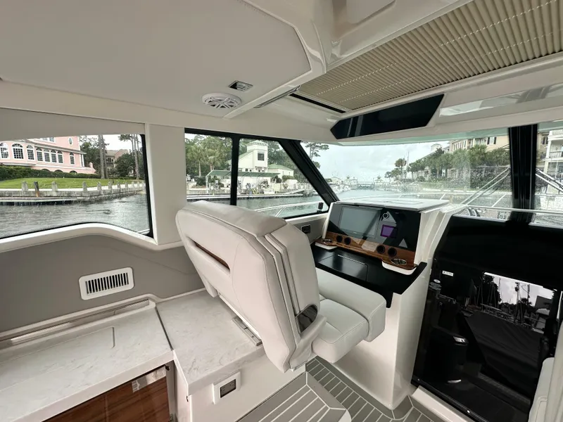 Slide: The Image of 2023 Tiara Yachts 43 LE interior with modern helm and luxurious seating. - 16