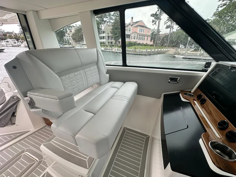 Slide: The Image of 2023 Tiara Yachts 43 LE interior with luxurious seating and modern dashboard. - 19
