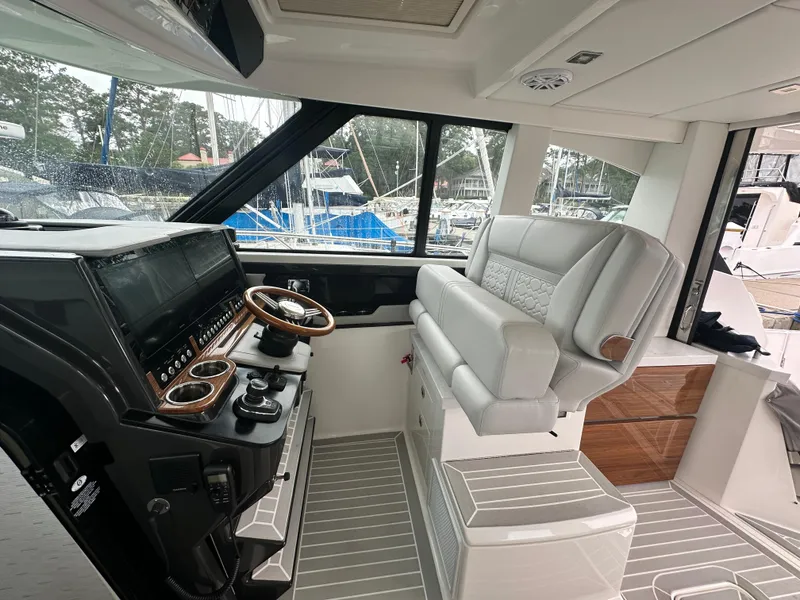 Slide: The Image of 2023 Tiara Yachts 43 LE helm with luxurious seating and advanced controls. - 20
