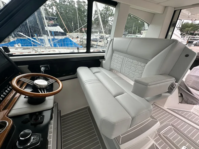 Slide: The Image of 2023 Tiara Yachts 43 LE interior with luxurious seating and steering wheel. - 21