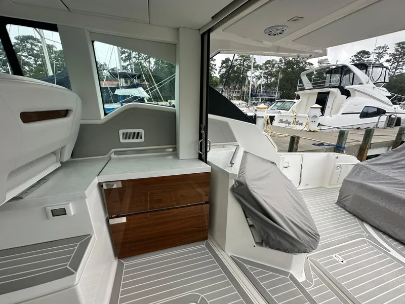 Slide: The Image of 2023 Tiara Yachts 43 LE interior with sleek design and modern amenities at a marina. - 25