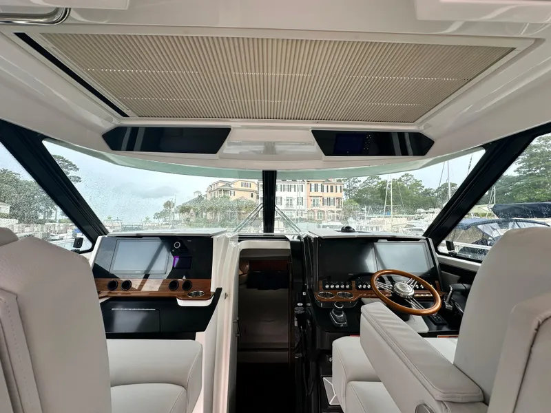 Slide: The Image of 2023 Tiara Yachts 43 LE helm with modern controls and luxurious seating. - 31