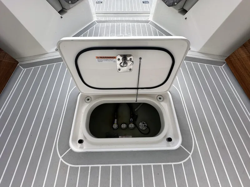 Slide: The Image of 2023 Tiara Yachts 43 LE deck hatch open, revealing storage compartment. - 34