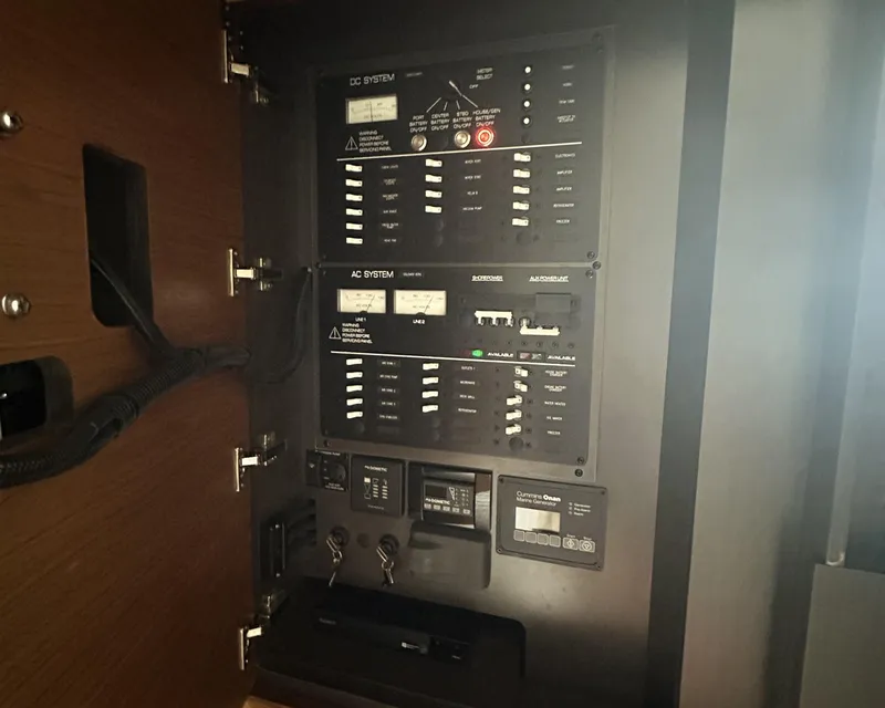 Slide: The Image of Electrical control panel on 2023 Tiara Yachts 43 LE, featuring AC and DC systems. - 35