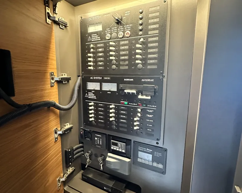 Slide: The Image of Electrical control panel inside 2023 Tiara Yachts 43 LE, showcasing AC and DC systems. - 36