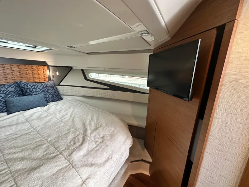 Slide: The Image of Luxurious 2023 Tiara Yachts 43 LE cabin interior with bed, TV, and modern design. - 40