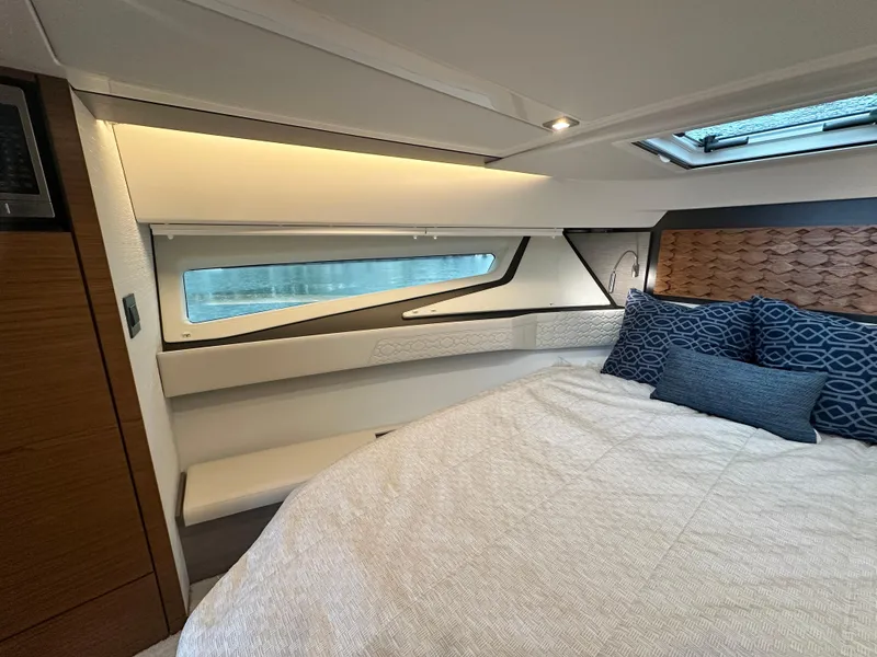 Slide: The Image of Luxurious 2023 Tiara Yachts 43 LE cabin interior with modern bedding and elegant lighting. - 43