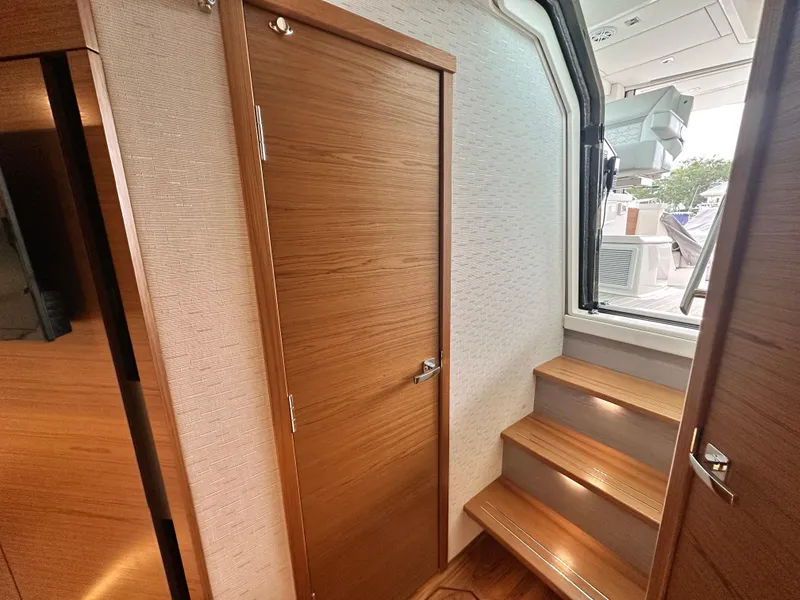 Slide: The Image of Interior of 2023 Tiara Yachts 43 LE, featuring wooden door and steps leading outside. - 45