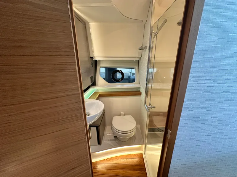 Slide: The Image of 2023 Tiara Yachts 43 LE bathroom with modern fixtures and wooden accents. - 46