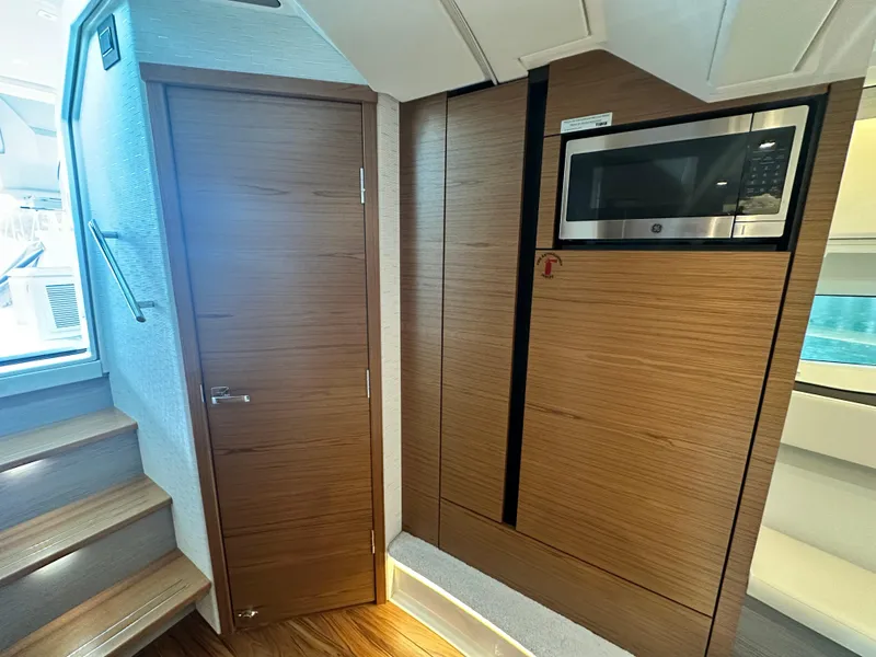 Slide: The Image of 2023 Tiara Yachts 43 LE interior with wooden cabinetry and built-in microwave. - 49