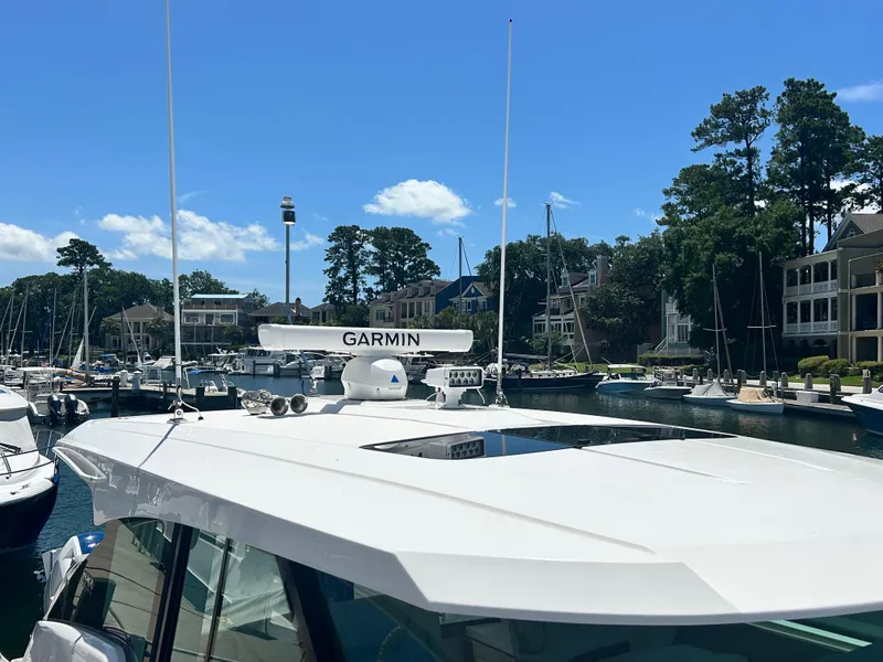 Slide: The Image of 2023 Tiara Yachts 43 LE docked in a marina, featuring Garmin equipment. - 5