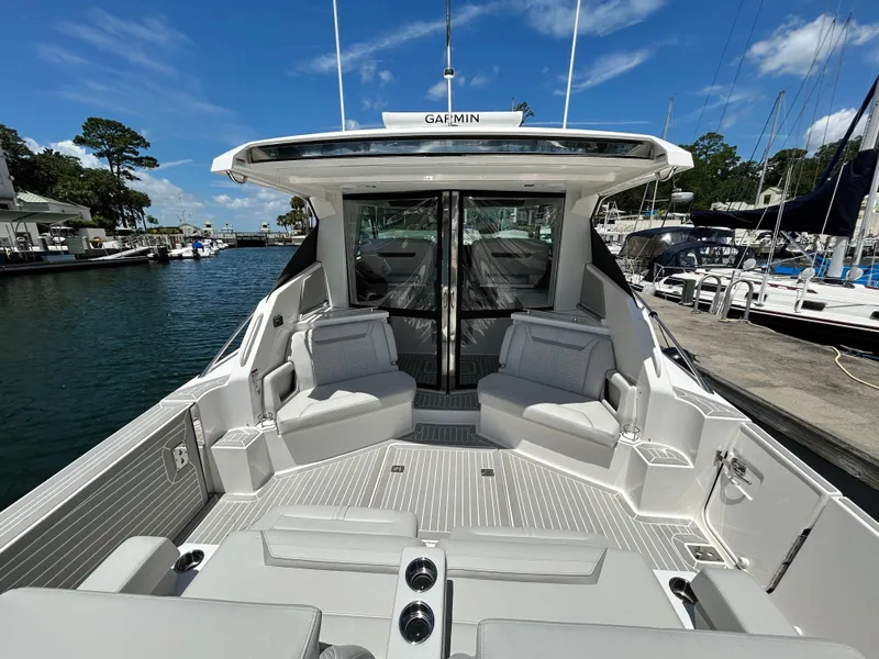 Slide: The Image of 2023 Tiara Yachts 43 LE luxury yacht interior with seating, docked at marina. - 7