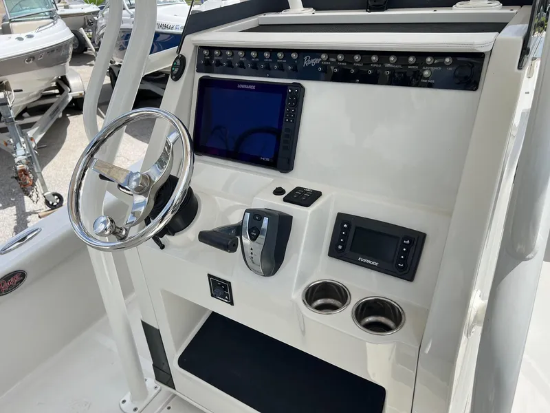 Slide: The Image of 2015 Ranger 2510 Bay boat console with steering wheel, navigation system, and control panel. - 13