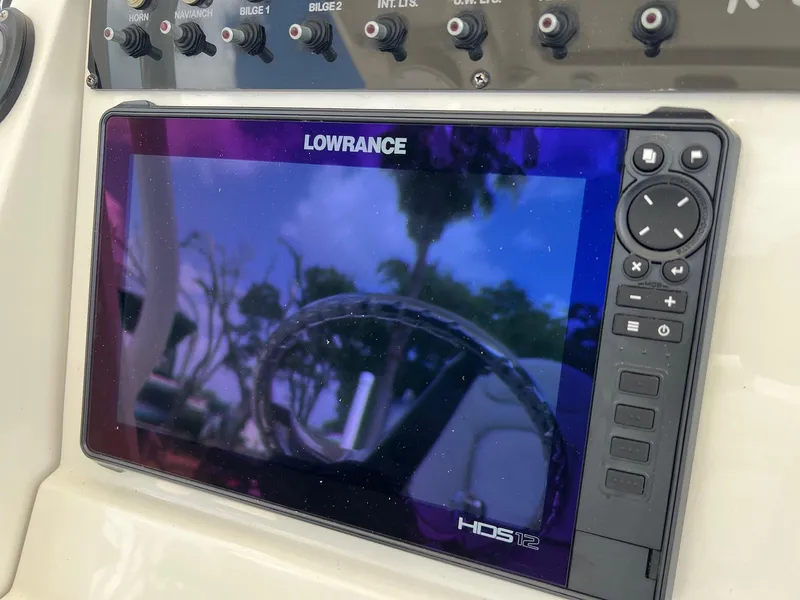 Slide: The Image of Lowrance HDS12 display on 2015 Ranger 2510 Bay boat dashboard with control switches. - 15