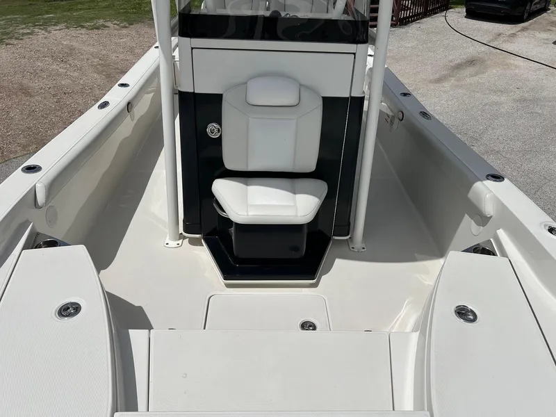 Slide: The Image of 2015 Ranger 2510 Bay boat interior with white seating and spacious deck. - 20