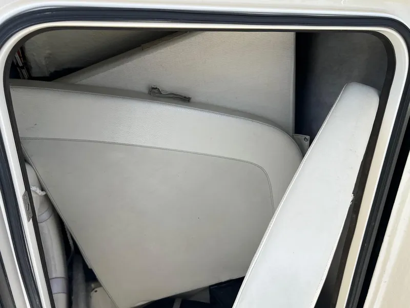 Slide: The Image of Storage compartment in a 2015 Ranger 2510 Bay boat with white interior panels. - 21