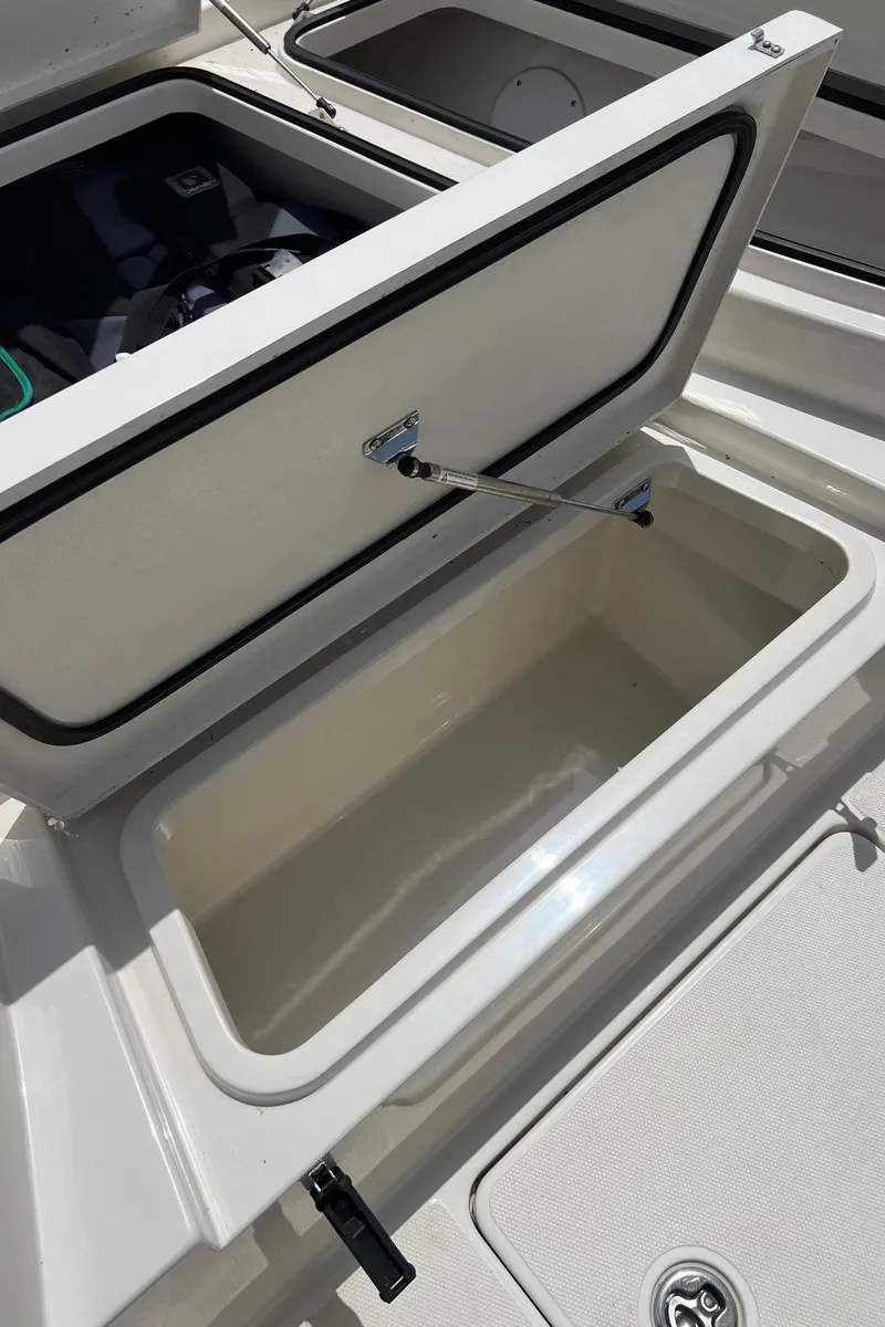 Slide: The Image of Open storage compartment on 2015 Ranger 2510 Bay boat, showcasing interior space. - 25