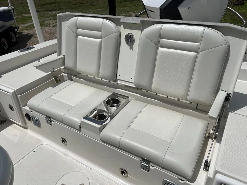 Slide: The Image of 2015 Ranger 2510 Bay boat with white cushioned seating and built-in cup holders. - 7
